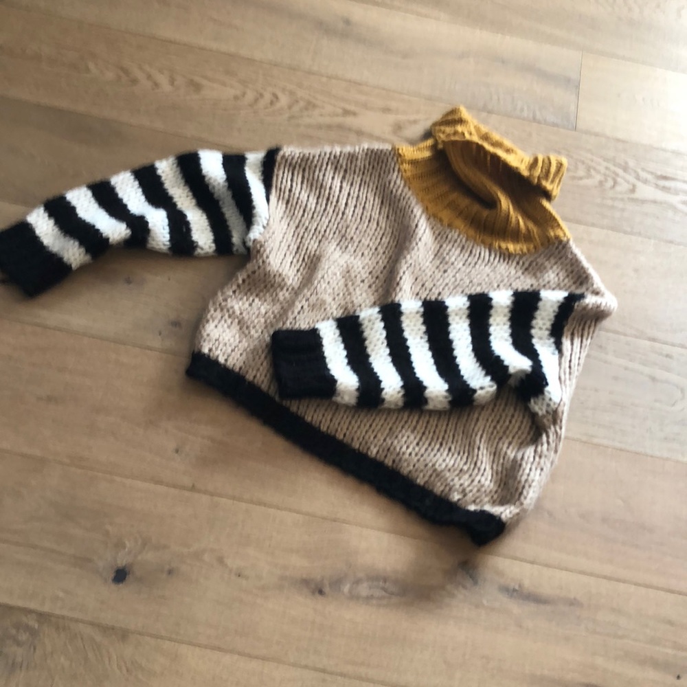Cowl neck sweater with black and white striped sleeves